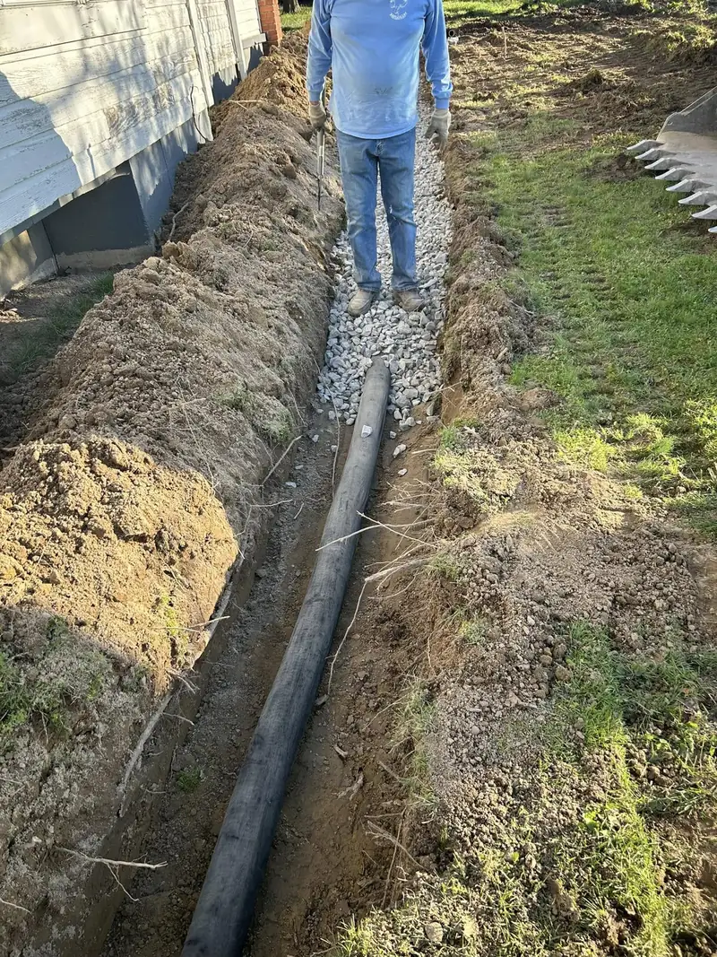 Drain pipe laid in a trench next to a house