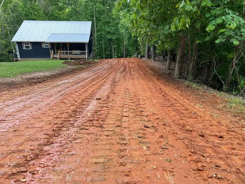 Driveway to a cabin cut and graded in red clay