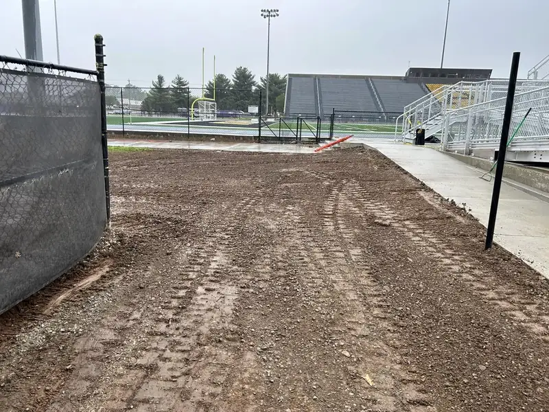 Site grading along the sideline of a school stadium