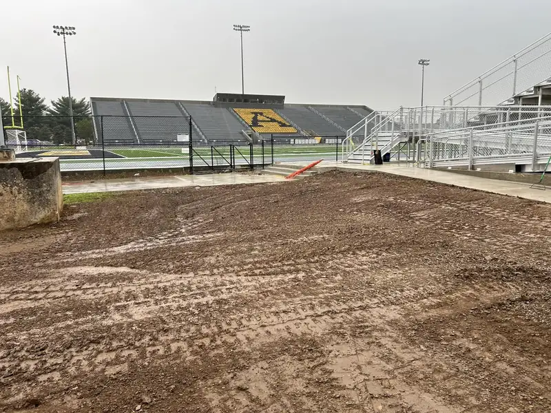 Finished grading next to a stadium track and field