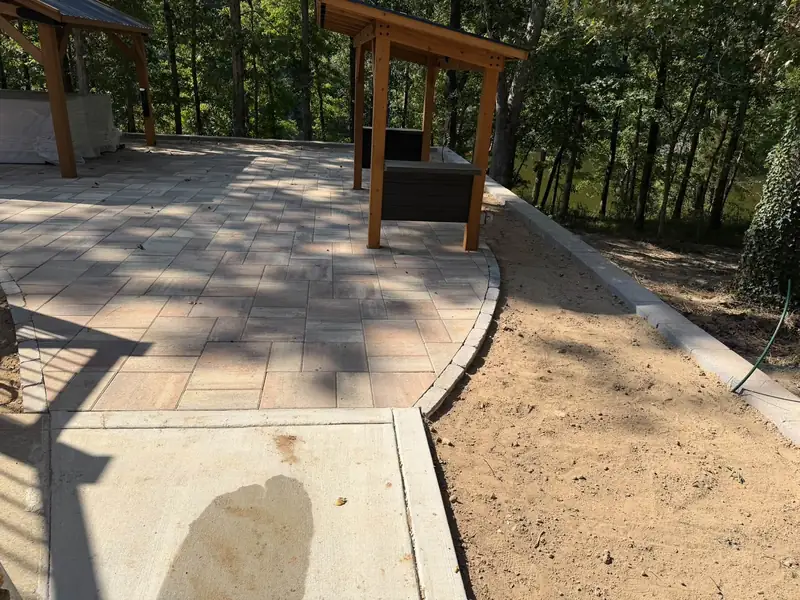 Paver patio with curved edging in a backyard