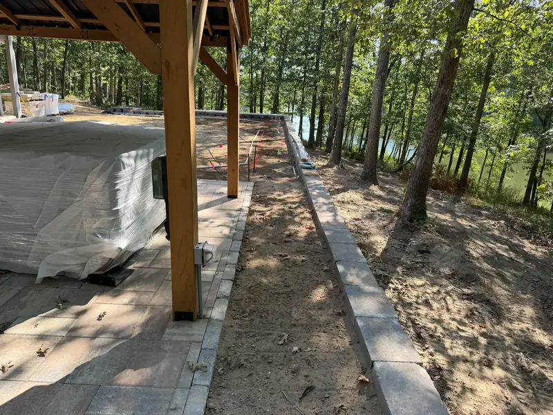 Paver walkway along a retaining wall at a lake house