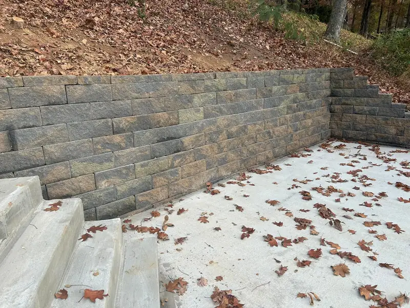 Block retaining wall around a new concrete patio